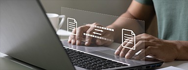 Hands on a laptop with icons for transferring documents and files