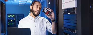 a server engineer installing Kingston DC SSD into the server array