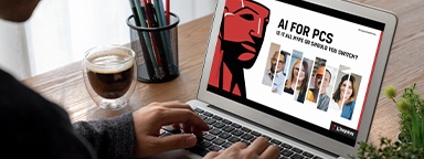 A man typing on a laptop keyboard with AI concept on screen