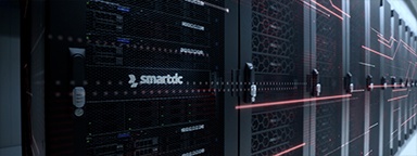 Enterprise server racks of a managed hosting provider with a man using a laptop computer.