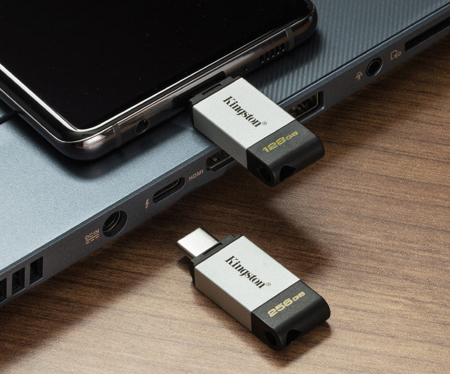 Android phone with a USB-C flash drive connected sitting on a laptop keyboard