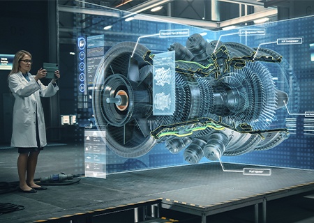 Ein Ingenieur hält ein Tablet in der Hand, das einen Motorentwurf in einer Augmented-Reality-App zeigt